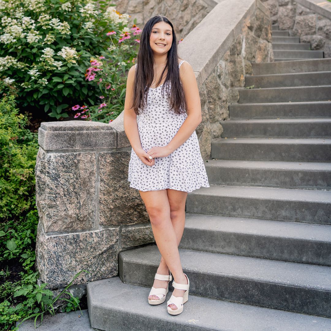 Alisa Romanovsky smiling at the bottom step of stairs.
