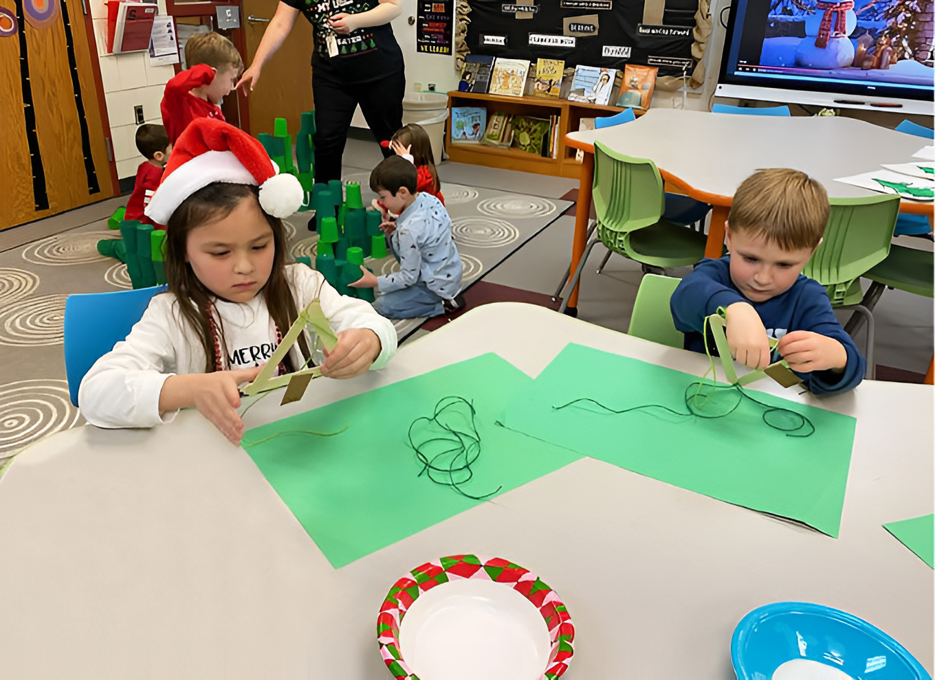 young students doing christmas crafts