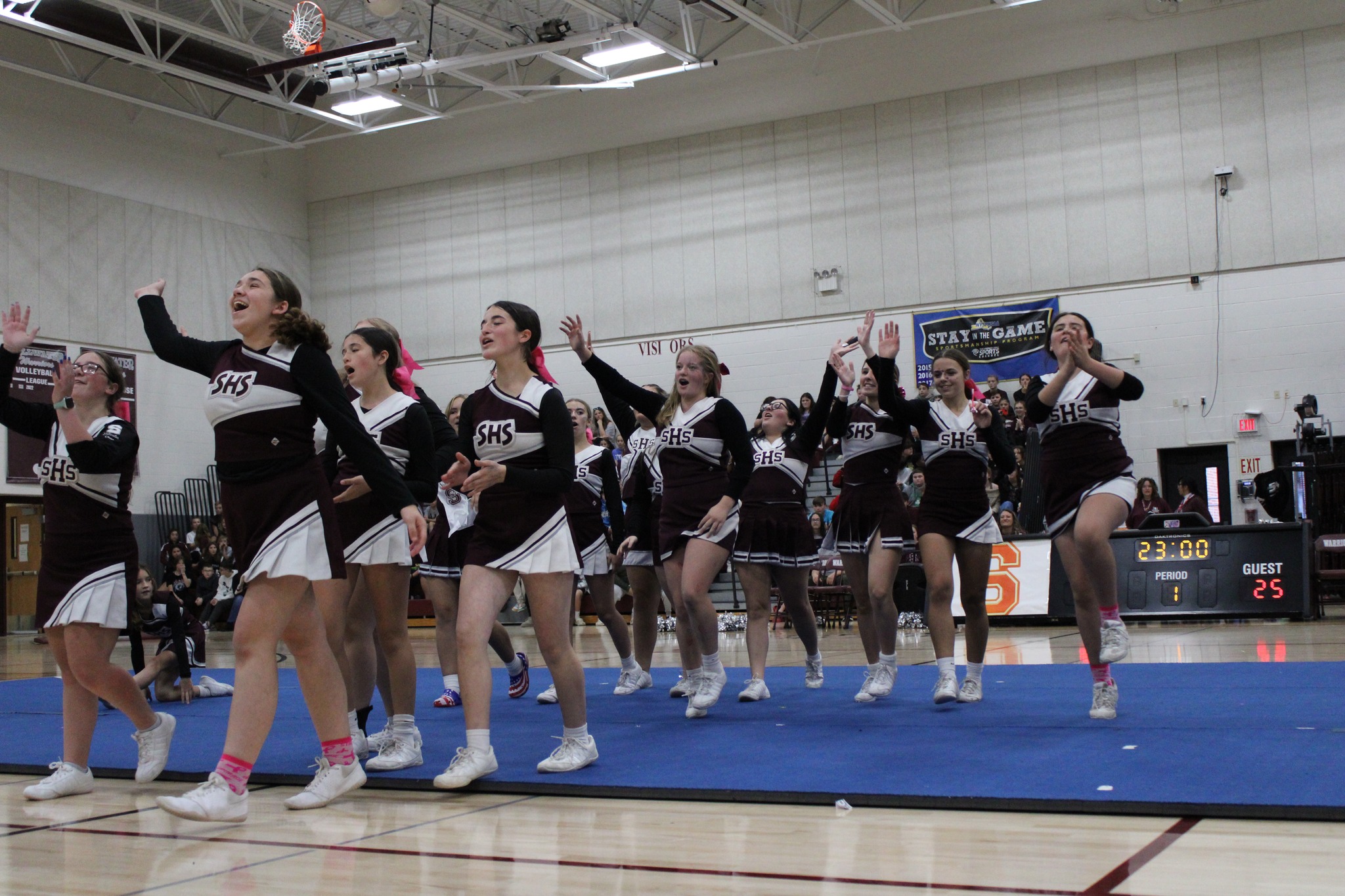 cheerleaders cheering in gymnasium