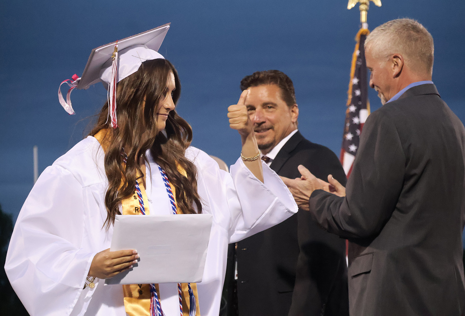 student receiving diploma during graduatin