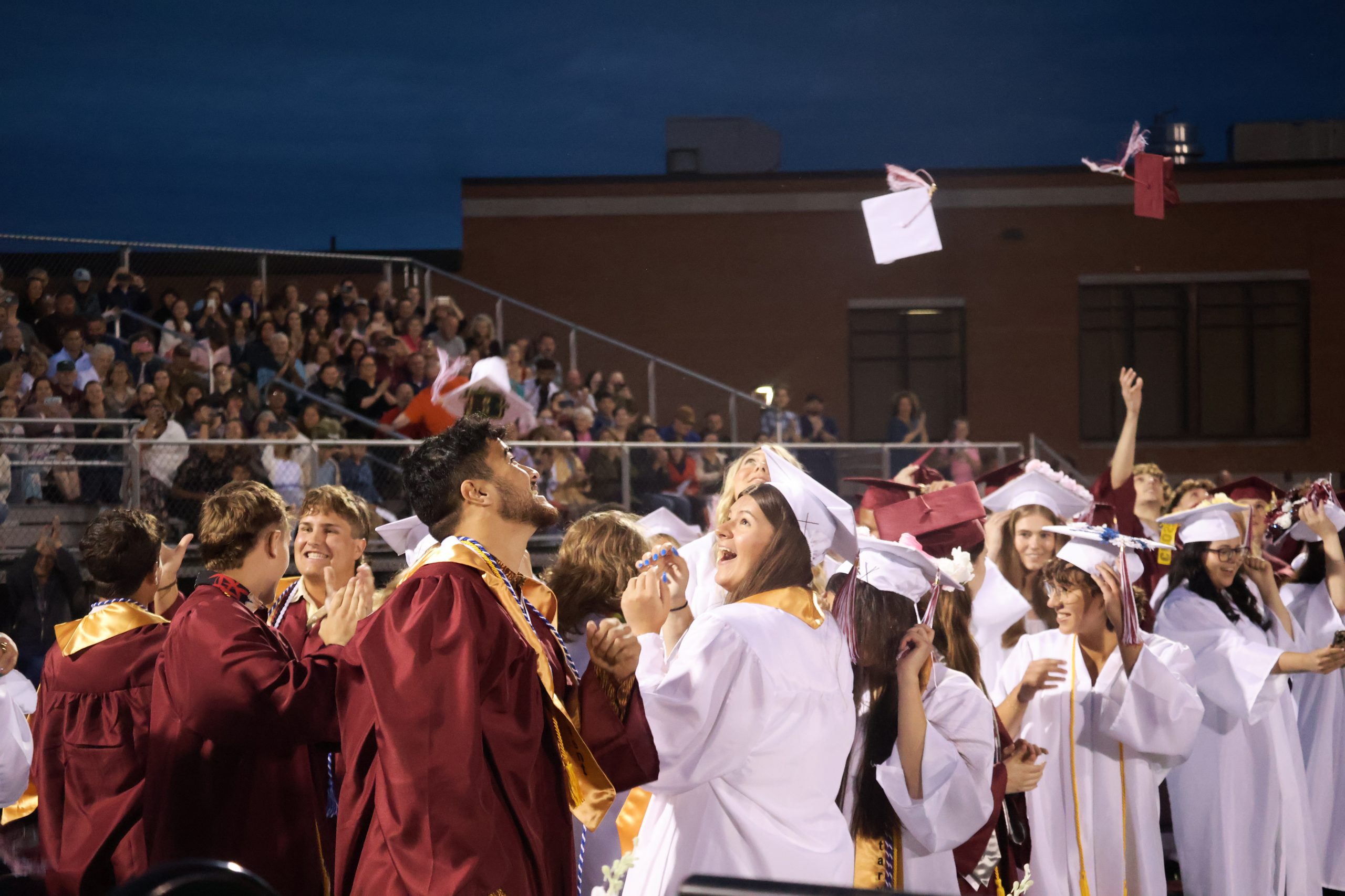 students throwing their caps in celebrating their graduation