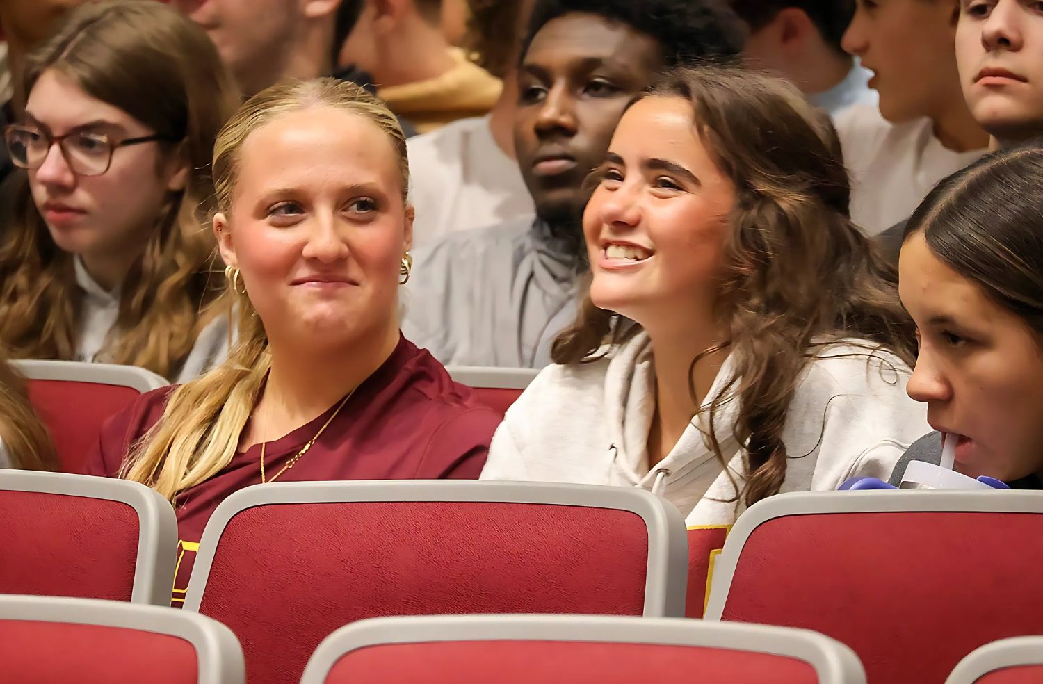 students posing for photo with thumbs up after graduating