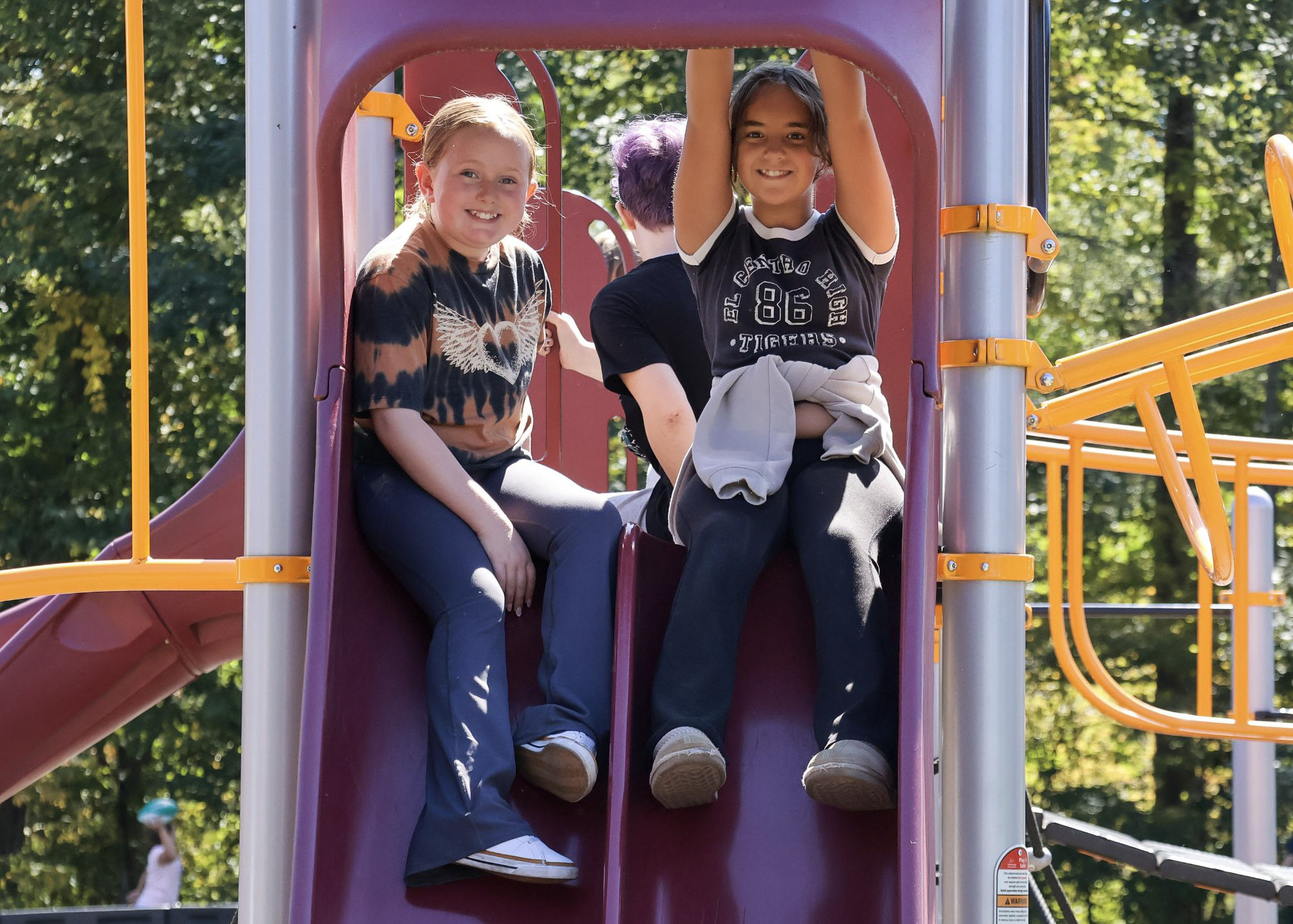 two students smiling at the playground