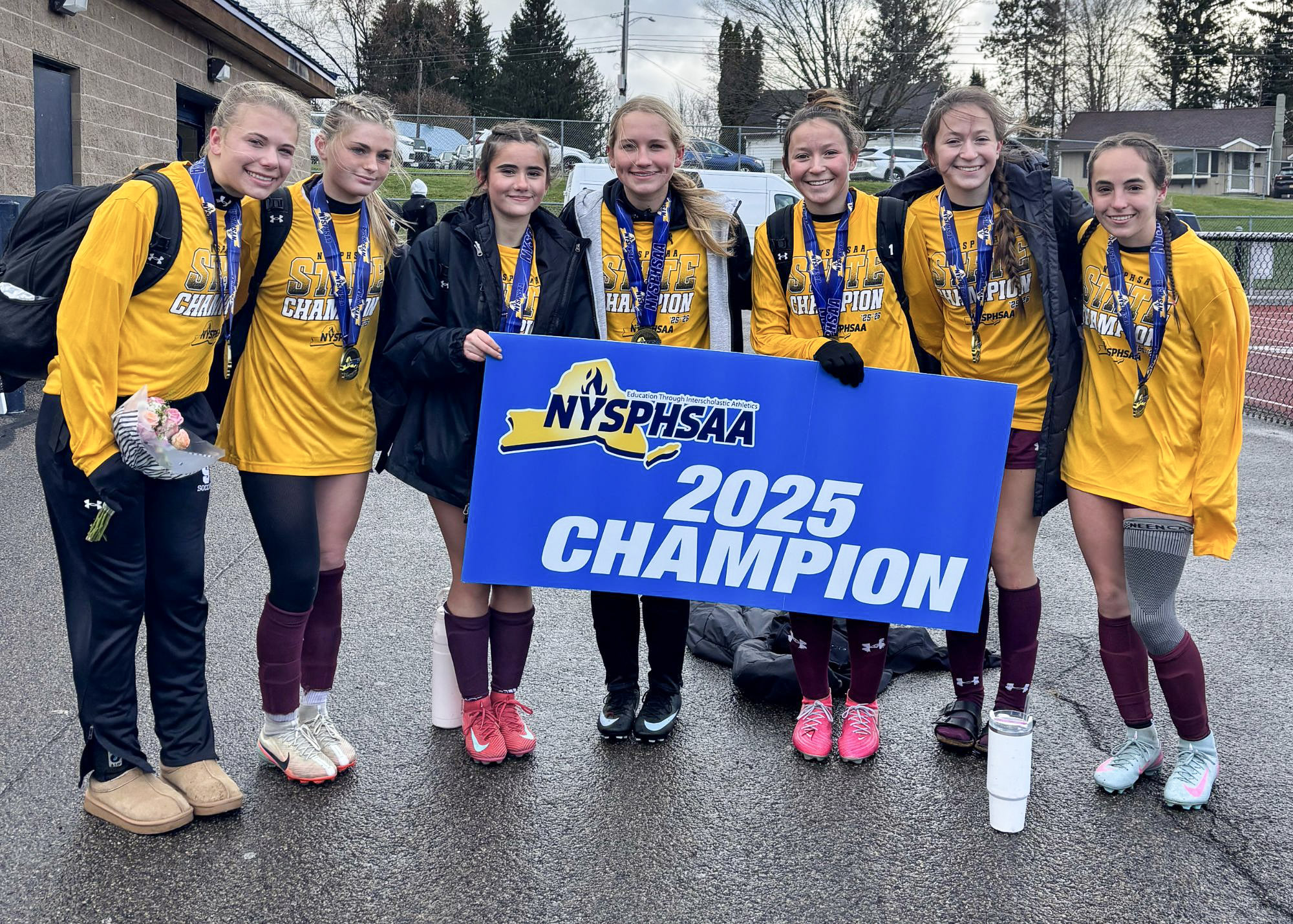 soccer team posing with banner that says sectional 2