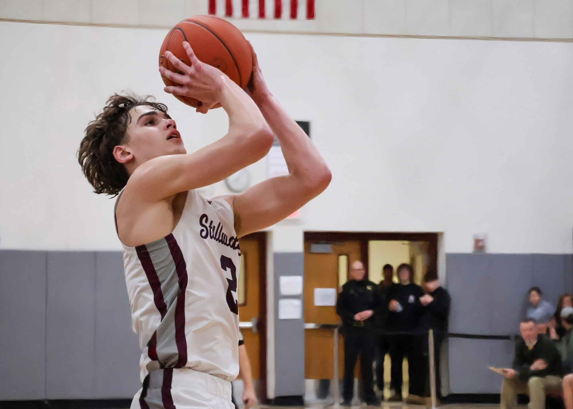 student with basketball with opposing team about to take ball as they score point